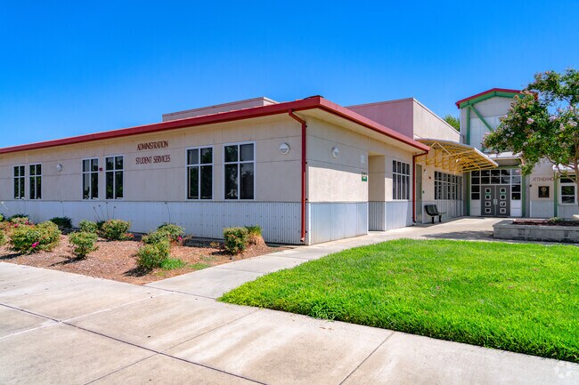 Green grass welcomes visitors to the River Valley High School office.