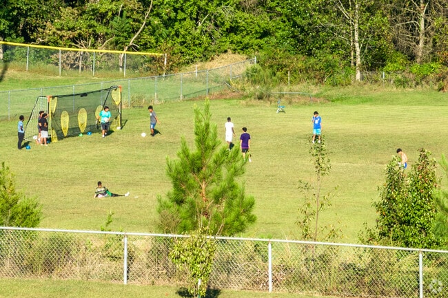 Kids play soccer on the field behind the Carl H. Russell Community Center in Winston-Salem.