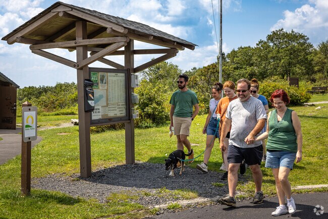 A family pauses their roadtrip to take in the fresh air and views at Big Pocono State Park.