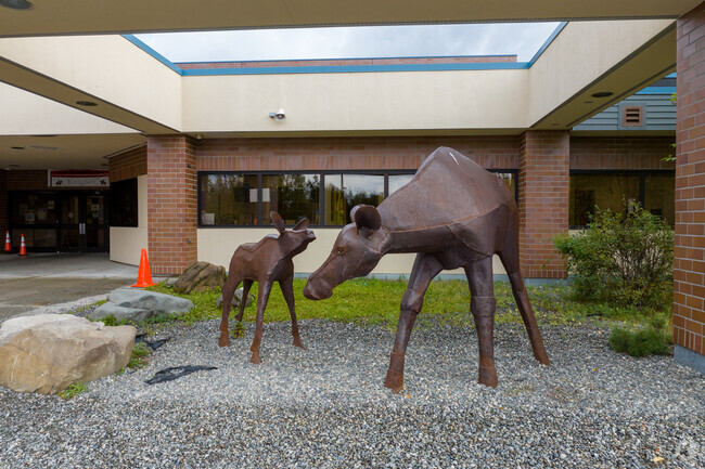 A statue of a deer and its fawn in front of Kasuun Elementary.