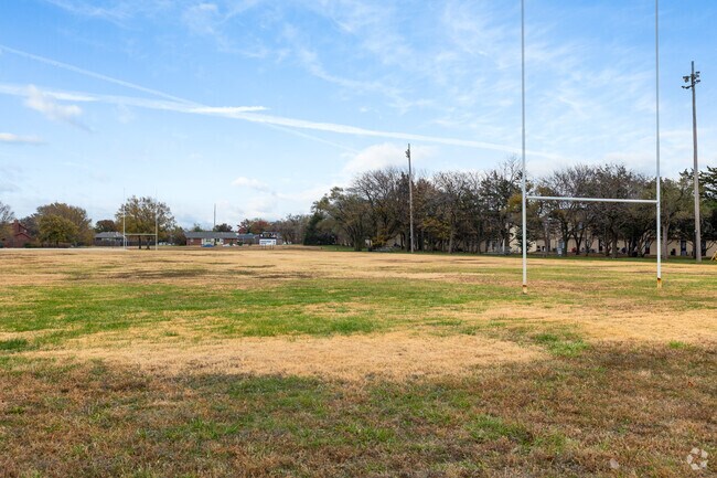 Friends get together for a game of football at Harrison Park near Cedar Lakes Village.