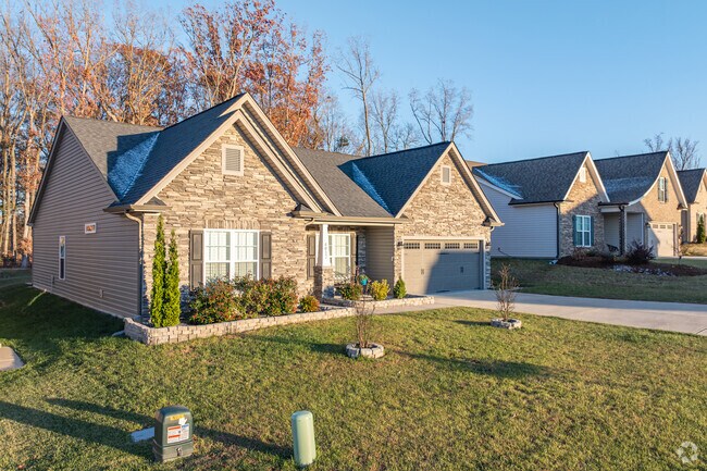 A row of newly constructed homes in Squire Davis showcases brick facades.