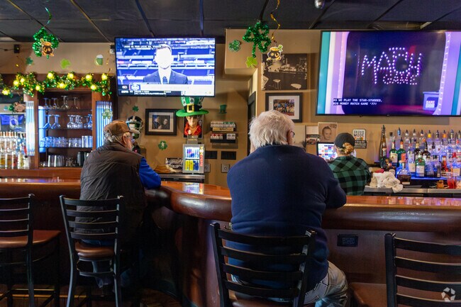 Patrons of Greg's place watch the game while having lunch in  Schererville.