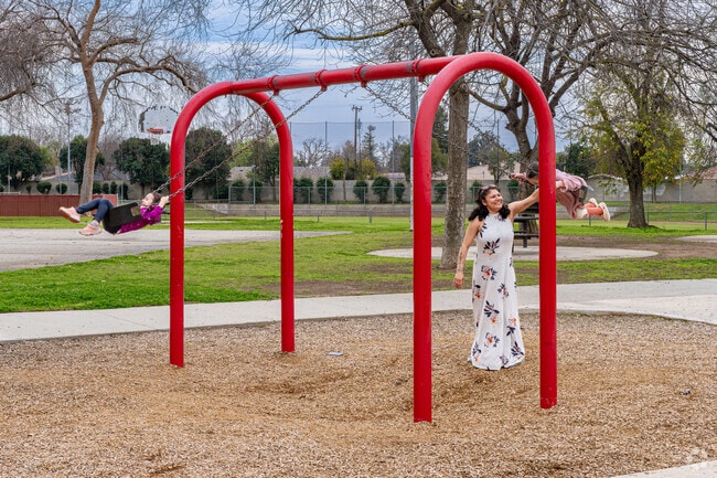 An Olive Drive Area mother enjoys swinging her children at Fruitvale Norris Park.
