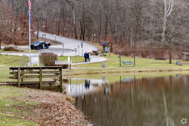 A couple enjoying the path around the pond at B-Y Park.