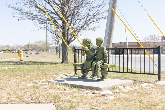 The sculpture of two kids sharing a birthday cake sits outside Pamela Hodson Elementary School.