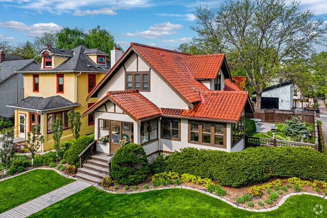 Craftsman-style homes meticulous landscaping beautify the neighborhood of East Bde Maka Ska.