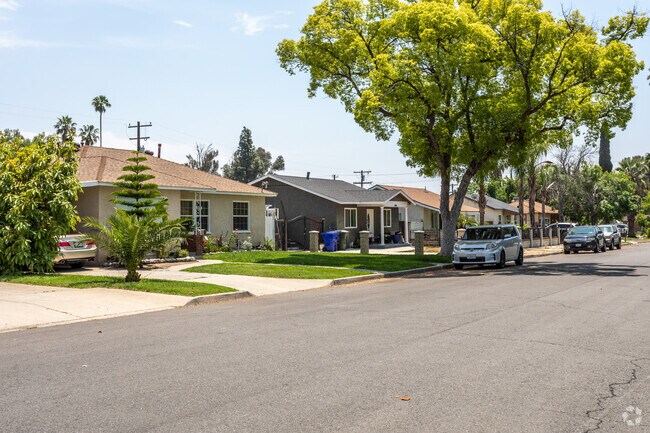 A row of single-family ranch homes in Wilson nestles among an abundance of trees.