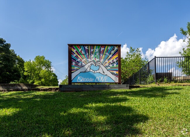 Choose Love painting signage is in an open field at Washington Elementary School.