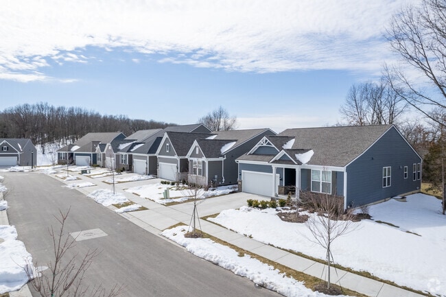 New ranch-style homes in Downtown Brighton's Bluffs at Spring Hill by Pulte Homes during winter.