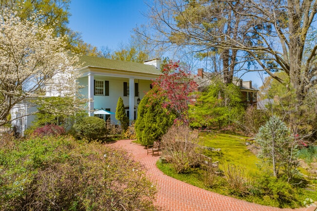 This Colonial in Chickasaw Gardens peeks out from behind its vibrant landscaping.
