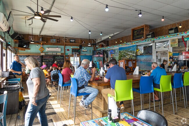 Enjoy your food and drinks in a casual outdoor atmosphere at TC's Front Porch in Navarre near Holley.
