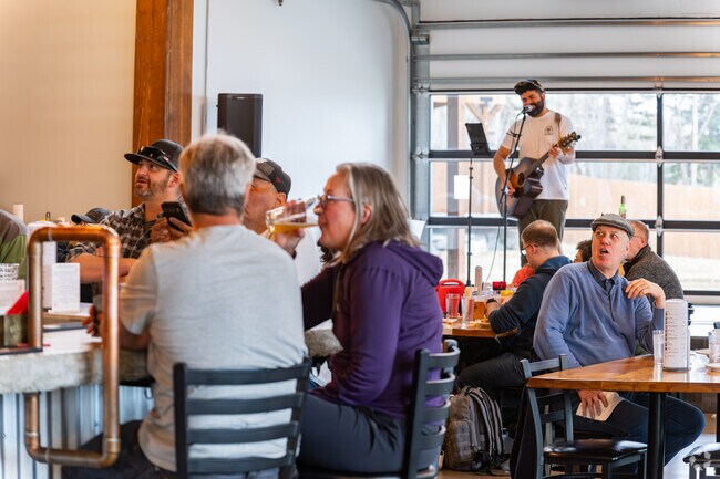 Big Lake residents react to a hockey game at Susitna Brewery while eating great food and enjoying live music.