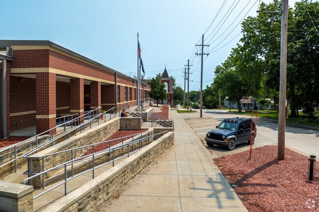 There is a sidewalk around the front of Central Elementary School.