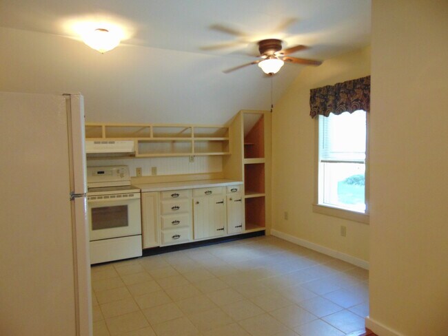 Kitchen from living room showing front window.