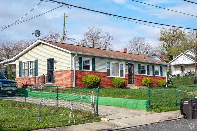A single-story ranch style home with a generous lawn