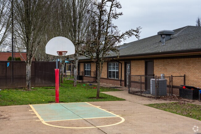 A basketball hoop sits next to Vancouver Knowledge Beginnings.
