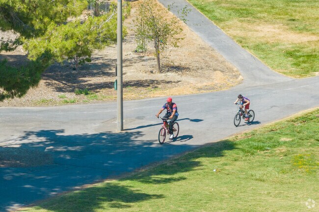 Bike riders enjoying a summer ride in Lake Cunningham in Hidden Glen, San Jose, California.