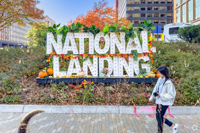 Amidst Crystal City's urban canvas, the National Landing sign stands in its bold silhouette.