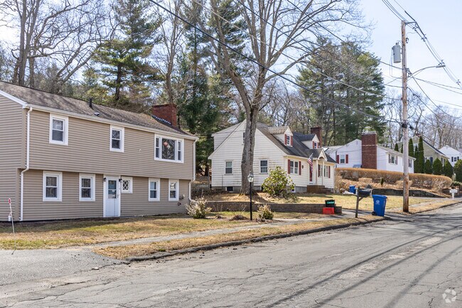 A row of homes including a Garrison and Cape Cod styled homes found in the Woodville neighborhood of Wakefield, MA.