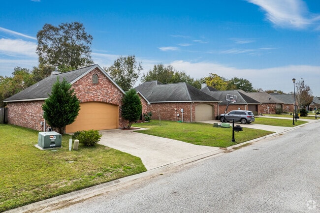 A row of traditional brick homes sits along a quiet Youngsville street.