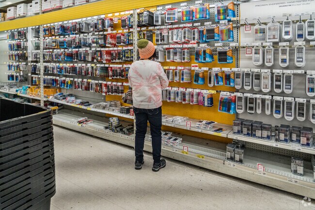 Customer browsing for office supplies at Office Depot near Harrington.