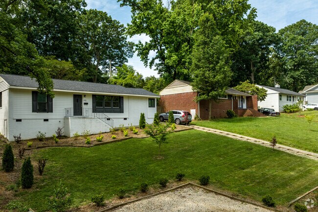 Ranch homes sit on slopping yards in the Collingwood neighborhood of Charlotte.