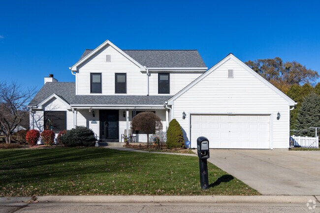 A crisp, white two-story home in the Bender neighborhood, showcasing a clean modern-traditional look, and a spacious front yard that adds to its polished suburban appeal.