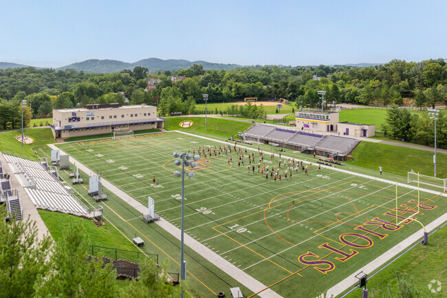 Patrick Henry High School band students practice for season at the football stadium.