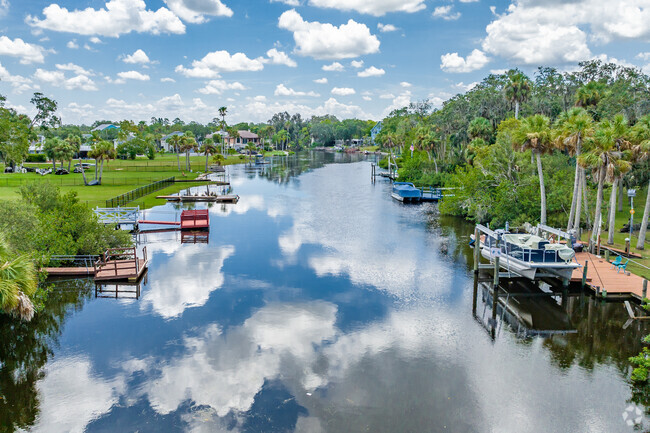 Bright puffy white clouds reflecting off of the Cotee river in New Port Richey South.