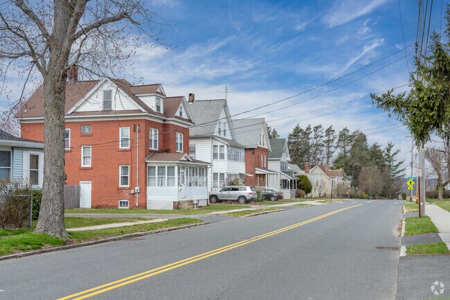 A row of homes in Chicopee Center are commonly seen with brick facades and vinyl-siding.