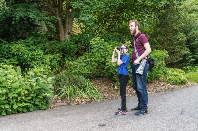 A photographer dad helps his son compose the perfect picture at Tyler Arboretum in Lima.