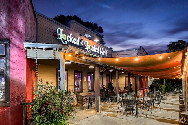 Friends gather at Locked & Loaded, a South Raleigh spot known for food and fun.