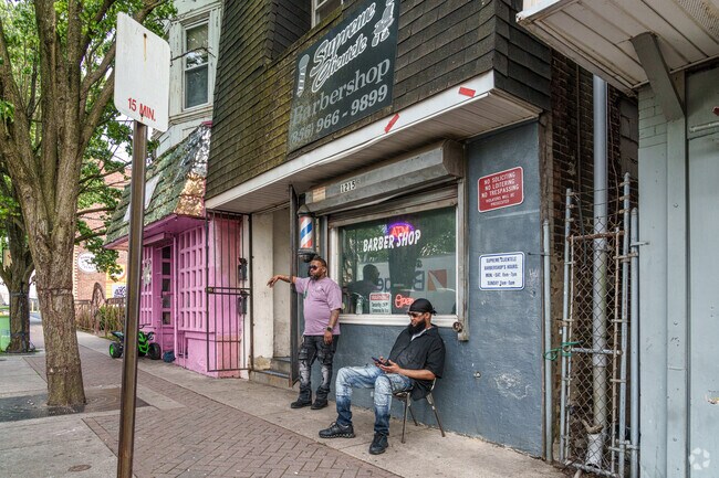 Friends in Gateway meet at Supreme Clientele Barbershop to chat and relax.