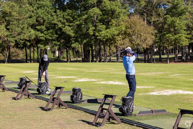 Head over to the Windcrest Golf Club to practice your swing at the driving range near Karen.