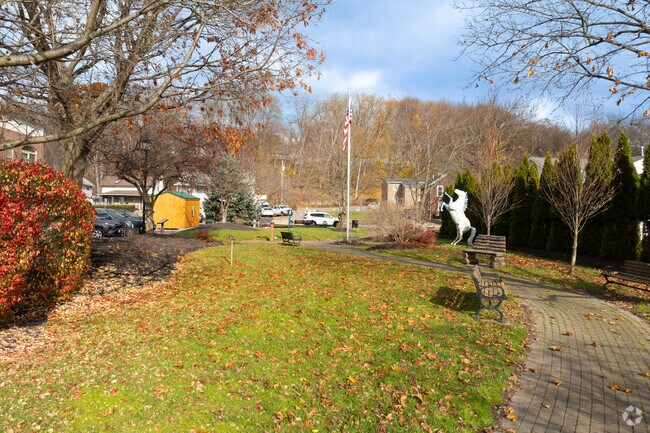 Mead Square Park in Victor features benches and gardens for relaxation and community gatherings.