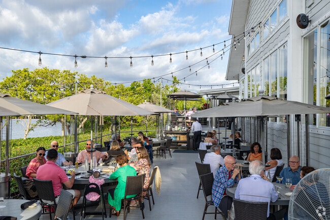 The Bay House is a popular restaurant with waterfront seating near Mediterra.