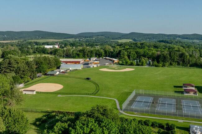 Warwick Valley schools feature athletic fields, tennis courts, and scenic rural views.