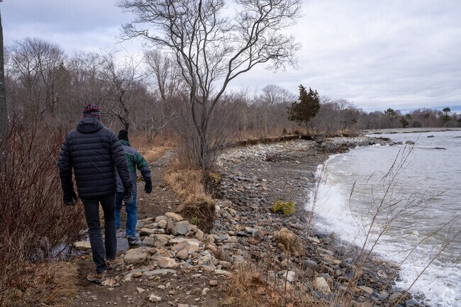 People hike along the ocean at Odiorne State Park in Hampton.