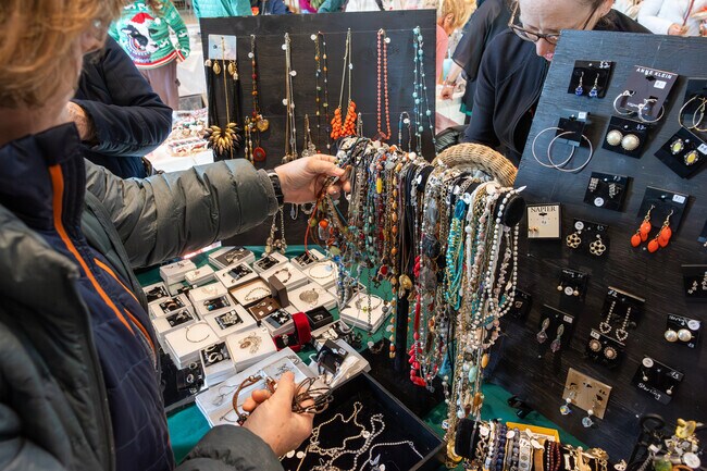 A local resident sifts through gorgeous jewelery at the Evergreen Faire in North Norwood.