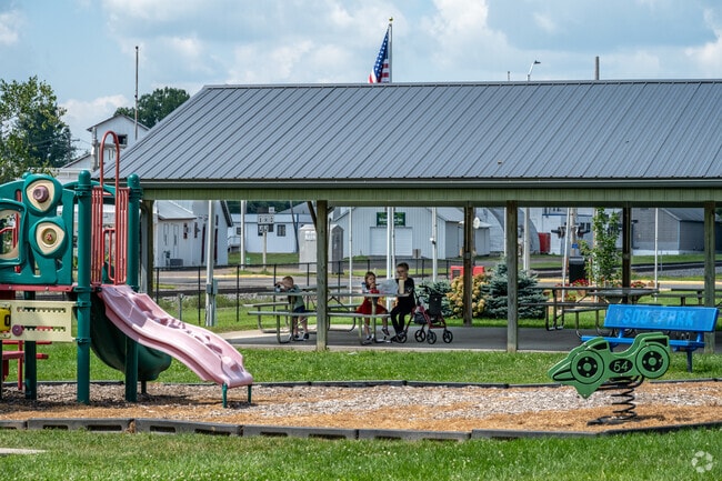 Families enjoy having a picnic at Soo Line Park.