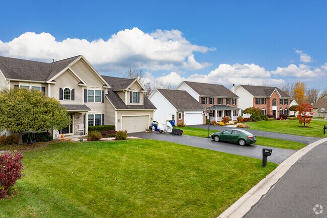 Colonial Revival homes with large windows sit on winding streets in Ontario.