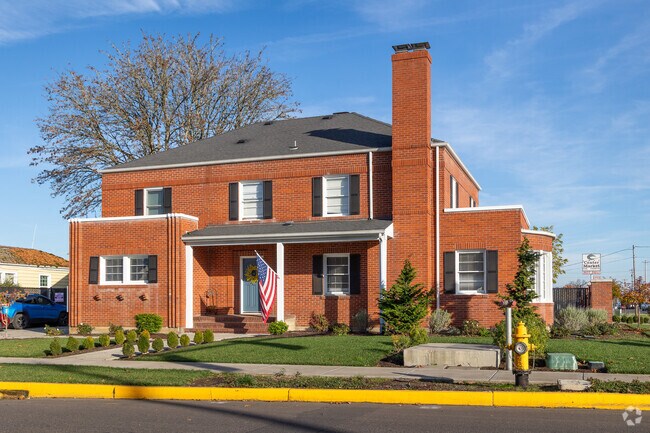 This brick Colonial Revival with rustic charm can be found in Dallas, Oregon.