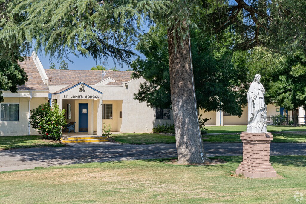 Beautiful evergreen trees greet students at St. John the Evangelist School in Wasco.