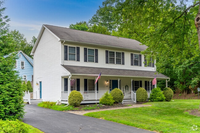 This Hillburn residence sits in a quiet suburban setting with manicured landscaping and nearby neighbors.