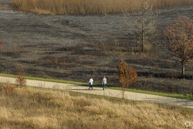 Residents of Third Lake go for a walk in a nearby forest preserve.