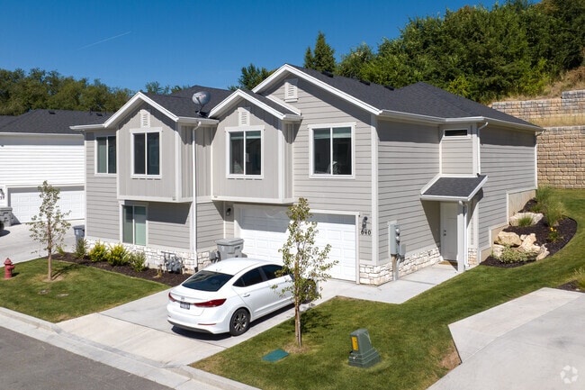 Manicured lawns and new builds give this street a clean, inviting look.