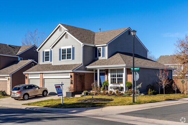 Traditional homes with window shutters and brick accents are common in Highlands Ranch.