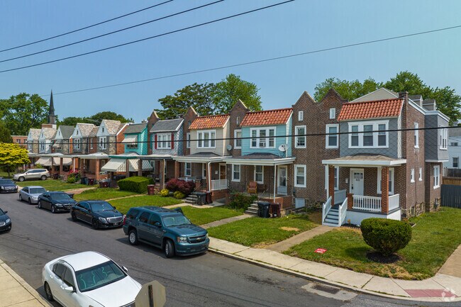 Single family row homes often feature small front porches and street parking in Baynard Village.