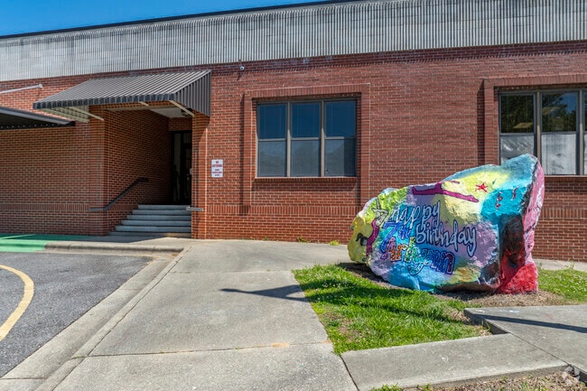 Students help to adorn the school boulder with colorful art each year at Davenport A+ School.